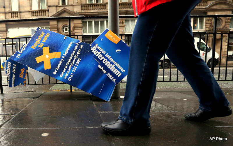 A damaged Scottish independence referendum advertising board is seen in Edinburgh, Scotland, Friday, Sept. 19, 2014. Scottish voters have rejected independence and decided that Scotland will remain part of the United Kingdom. The result announced early Friday was the one favored by Britain's political leaders, who had campaigned hard in recent weeks to convince Scottish voters to stay. It dashed many Scots' hopes of breaking free and building their own nation. (AP Photo/Scott Heppell)