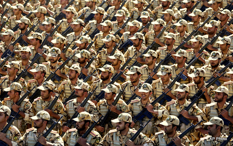 Members of the Iran's army march during an annual military parade marking the 34th anniversary of outset of the 1980-88 Iran-Iraq war, in front of the mausoleum of the late revolutionary founder Ayatollah Khomeini just outside Tehran, Iran, Monday, Sept. 22, 2014.