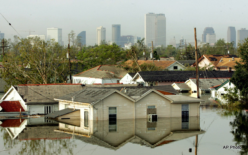 A neighborhood of houses underwater up to their roofs after Hurricane Katrina.