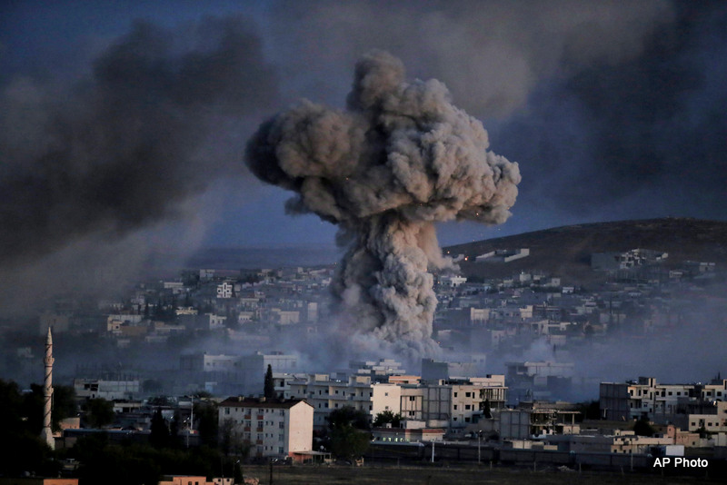 Thick smoke from an airstrike by the US-led coalition rise in Kobani, Syria