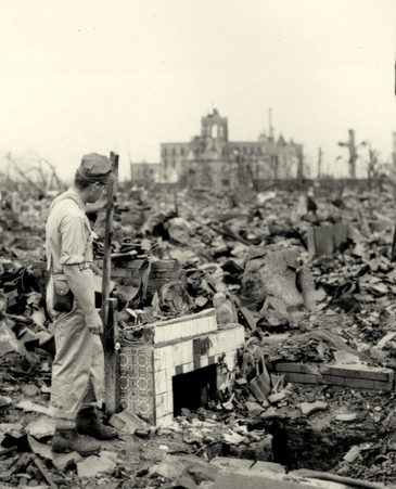 An unidentified man stands next to a tiled fireplace where a house once stood in Hiroshima, Japan, on Sept. 7, 1945. The vast ruin is a result of "Little Boy," the uranium atomic bomb detonated on Aug. 6 by the U.S.