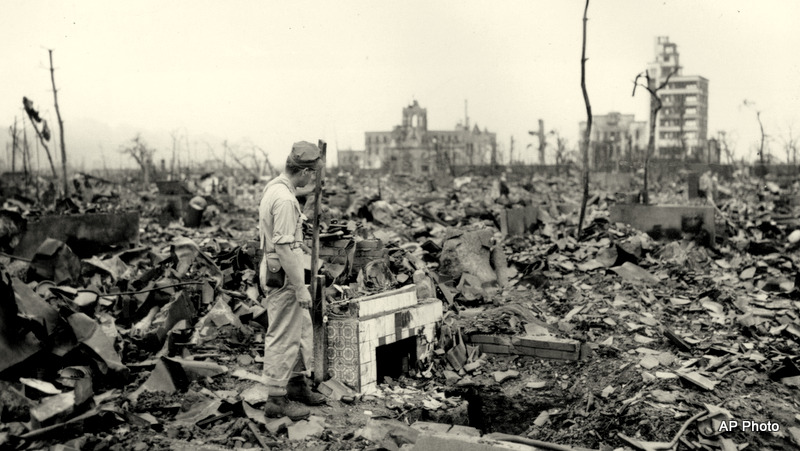 An unidentified man stands next to a tiled fireplace where a house once stood in Hiroshima, Japan, on Sept. 7, 1945.  The vast ruin is a result of "Little Boy," the uranium atomic bomb detonated on Aug. 6 by the U.S.