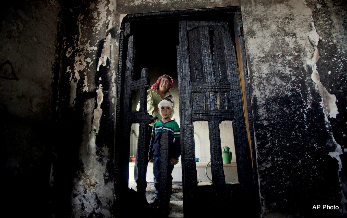 Palestinians inspect damages of a mosque following an attack in the West Bank village of Mughayer, north of Ramallah, Wednesday, Nov. 12, 2014. An attack against a mosque in a West Bank village early on Wednesday ignited a fire that destroyed its first floor, the village's mayor said, blaming Jewish settlers for the attack.(AP Photo/Majdi Mohammed)