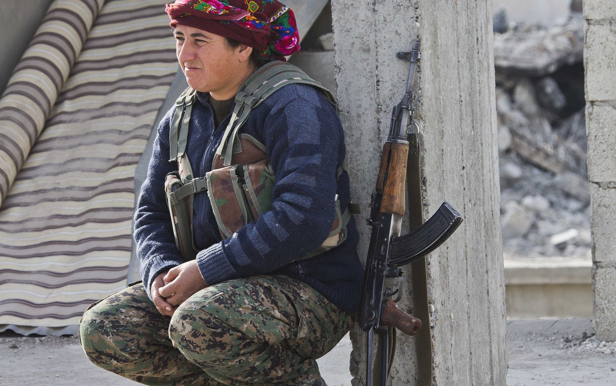 Acommander of the Kurdish womenís self-defense force, known by its Kurdish acronym YPJ, takes a break in Kobani, Syria. (AP/Jake Simkin)