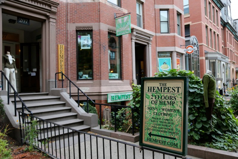 A sign welcomes visitors to browse two floors of hemp clothes and other goodes, with a staircase leading up to the main entrance and a display mannequin showing off a hemp dress.