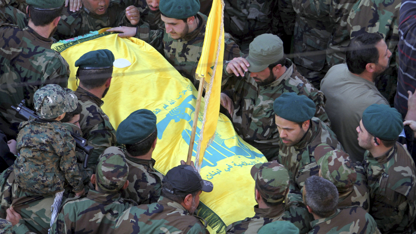 Hezbollah fighters carry the coffin of Hezbollah member Mohammad Issa who was killed in an airstrike that killed six members of the Lebanese militant group and an Iranian general in Syria, during his funeral procession, in the southern village of Arab Salim, Lebanon, Tuesday, Jan. 20, 2015. Hezbollah has accused Israel of carrying out Sunday's airstrike, which occurred on the Syrian side of the Golan Heights. Issa was the highest-ranking among the group, and was among the senior cadres who headed the group's operations in Syria against the Sunni-led rebellion. (AP Photo/Mohammed Zaatari)