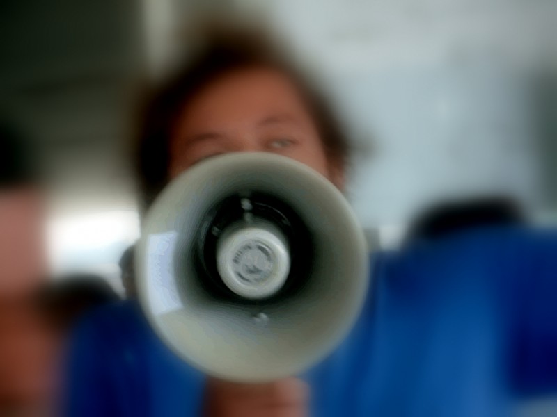 File: A protester holds a bullhorn.