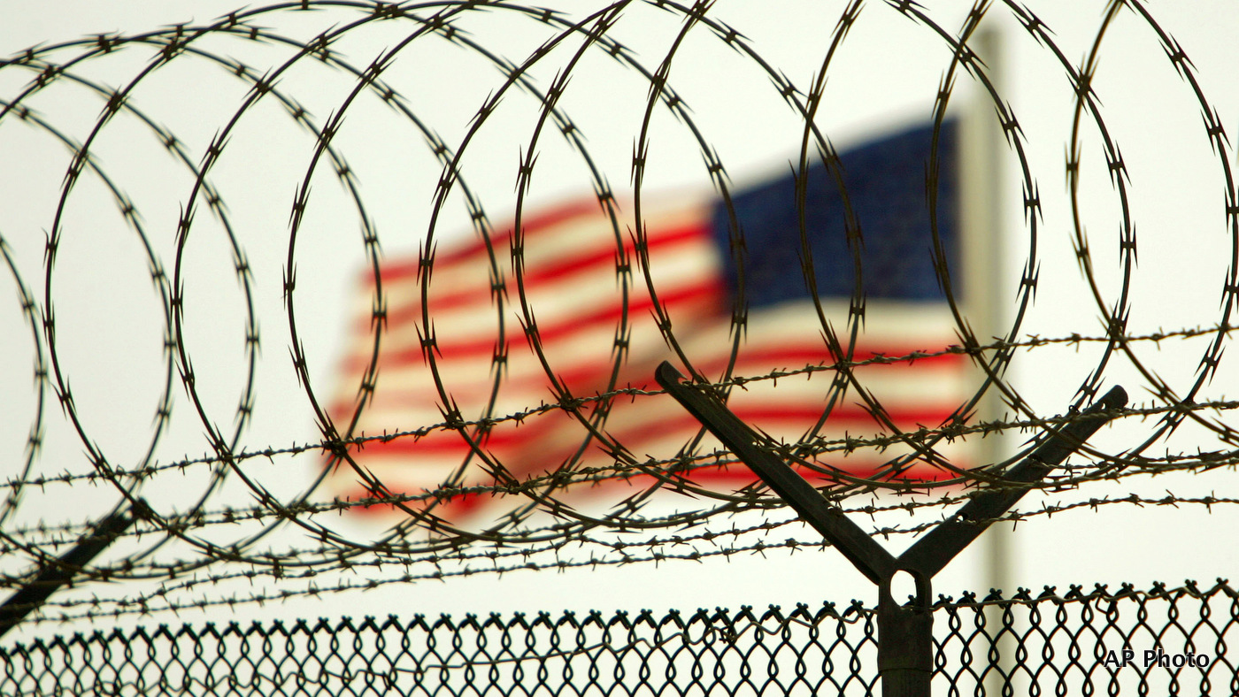 In this photo reviewed by US military officials, an American flag waves within the razor wire-lined compound of Camp Delta prison, at the Guantanamo Bay U.S. Naval Base, Cuba on Tuesday, June 27, 2006. The Supreme Court this week is expected to rule on the legality of President Bush's decision to create U.S. military tribunals for the detainees at Guantanamo, the first such tribunals since World War II.