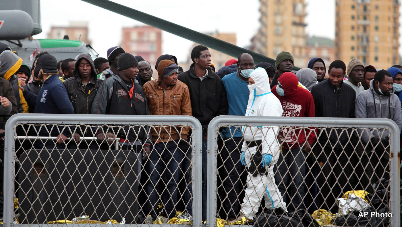 Migrants wait to disembark from a tug boat after being rescued in Porto Empedocle, Sicily, southern Italy, Tuesday, Feb. 17, 2015. (AP Photo/Francesco Malavolta)