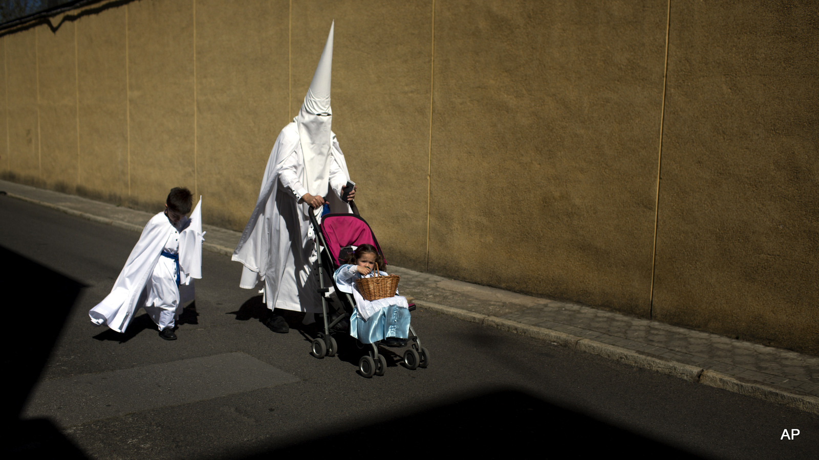 Penitents from the La Paz brotherhood walk to the church to take part in a procession in Seville, Spain, Sunday, March 29, 2015. Hundreds of processions take place throughout Spain during the Easter Holy Week.