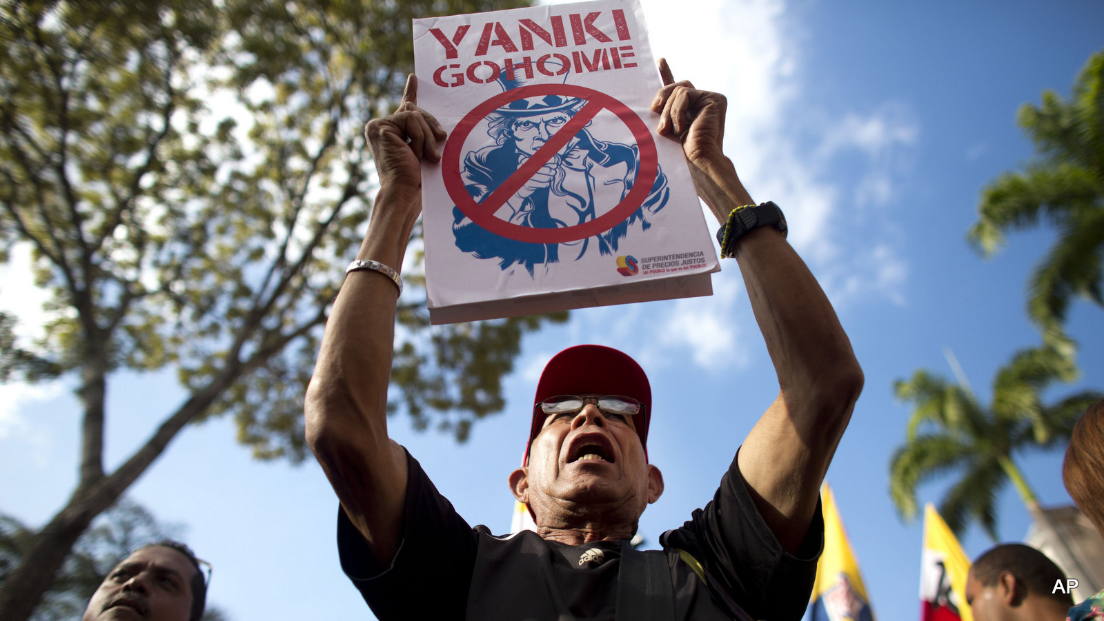 A protester holds up an poster of Uncle Sam during a rally protesting U.S. regime change efforts in Venezuela at the Miraflores presidential palace in Caracas, Venezuela. (AP/Ariana Cubillos)