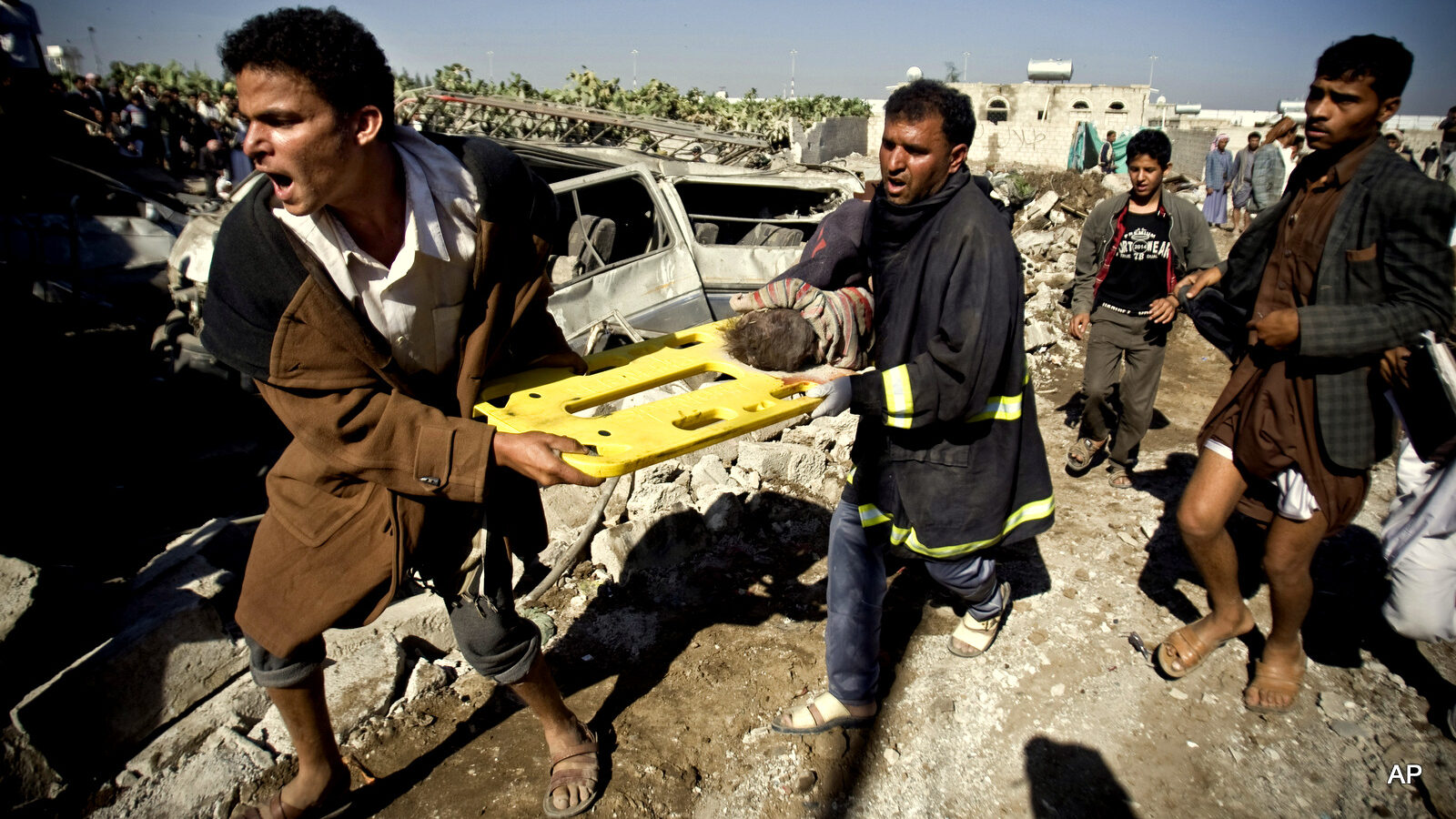 YemenPeople carry the body of a child they uncovered from under the rubble of houses destroyed by Saudi airstrikes near Sanaa Airport, Yemen, Thursday, March 26, 2015. Saudi Arabia launched airstrikes Thursday targeting military installations in Yemen held by Shiite rebels who were taking over a key port city in the country's south and had driven the embattled president to flee by sea, security officials said.