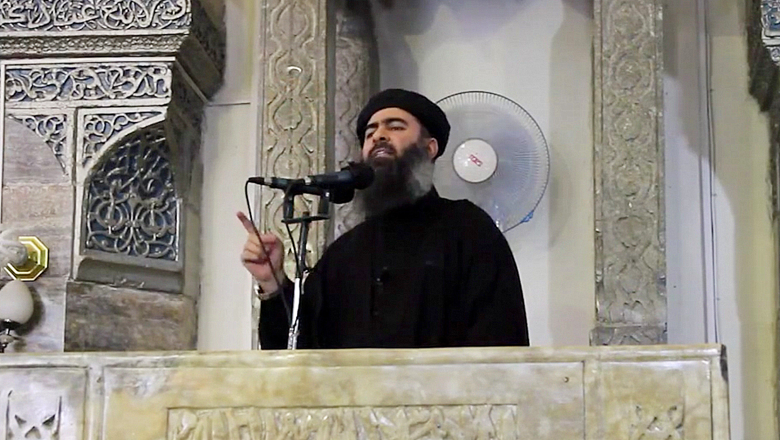 The leader of the Islamic State group, Abu Bakr al-Baghdadi delivering a speech an ISIS overrun mosque in what would be a rare - if not the first - public appearance by the shadowy militant. 