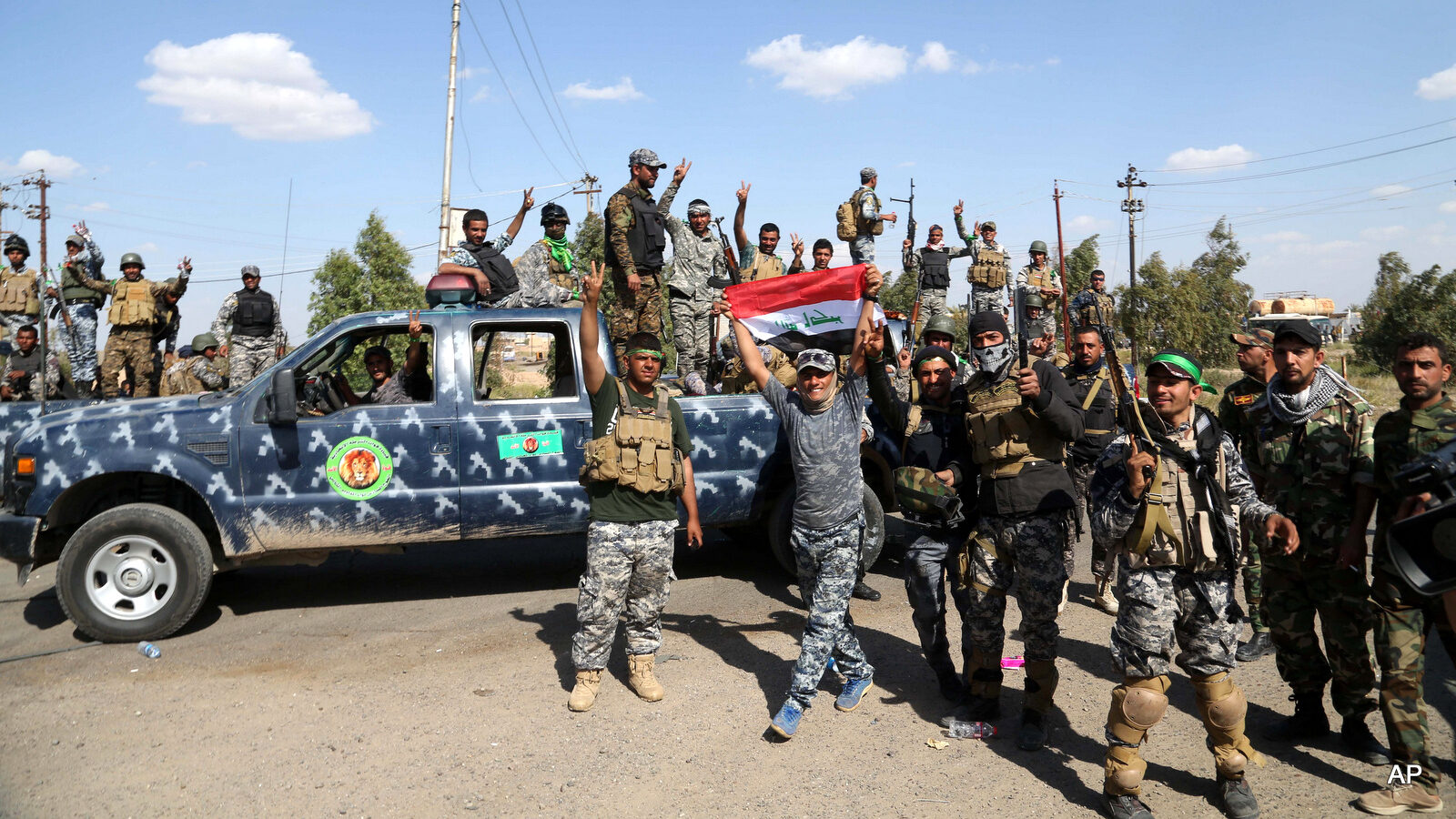 Iraqi security forces prepare to attack Islamic State extremist positions in Tikrit, 130 kilometers (80 miles) north of Baghdad, Iraq, Thursday, March 26, 2015. Iraqi troops started the final phase of an offensive to recapture Saddam Hussein's hometown of Tikrit on Thursday, a military official said, just hours after the United States launched airstrikes on the Islamic State held city. (AP Photo/Khalid Mohammed)