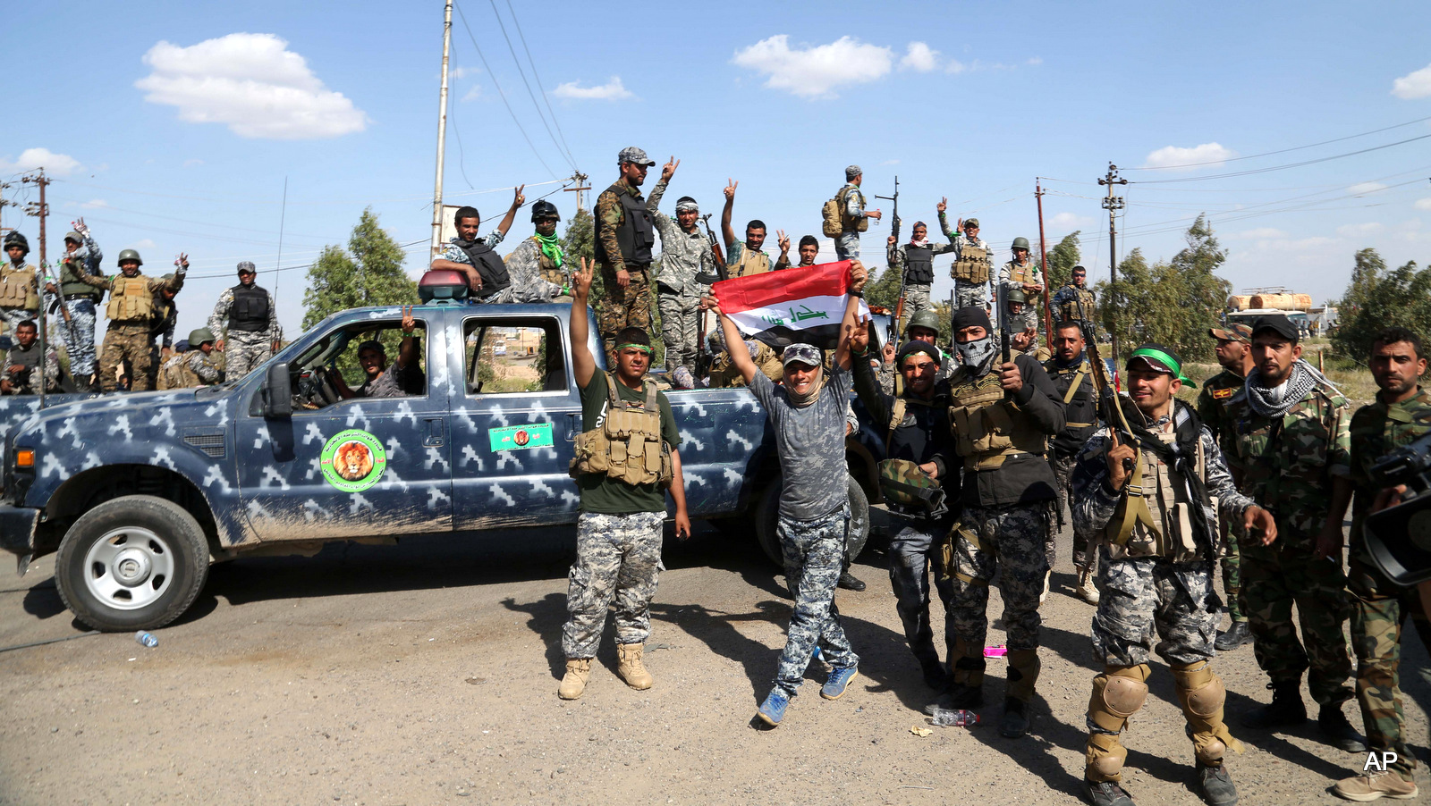 Iraqi security forces prepare to attack Islamic State extremist positions in Tikrit, 130 kilometers (80 miles) north of Baghdad, Iraq, Thursday, March 26, 2015. Iraqi troops started the final phase of an offensive to recapture Saddam Hussein's hometown of Tikrit on Thursday, a military official said, just hours after the United States launched airstrikes on the Islamic State held city. (AP Photo/Khalid Mohammed)