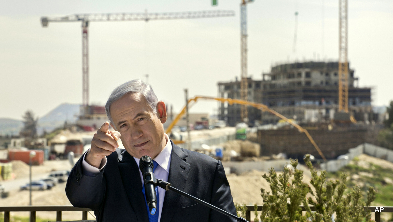 Israeli Prime Minister Benjamin Netanyahu talks as he visits a construction site in  Har Homa, east Jerusalem, Monday March 16, 2015, a day ahead of legislative elections. Netanyahu is seeking his fourth term as prime minister. 