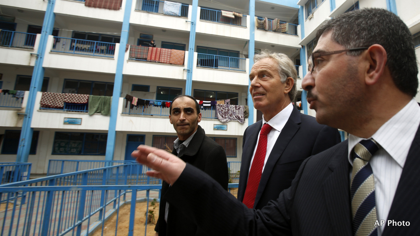Middle East peace envoy and former British Prime Minister Tony Blair, center, visits a United Nations run school sheltering Palestinians, whose homes were destroyed during Israel's war on Gaza City, Sunday, Feb. 15, 2015. (AP/Suhaib Salem)