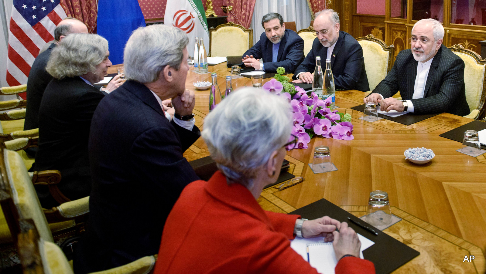 From left: Robert Malley, of the US National Security Council, US Secretary of Energy Ernest Moniz, US Secretary of State John Kerry, US Under Secretary for Political Affairs Wendy Sherman, Iranian Deputy Foreign Minister Abbas Araghchi, Head of Iranian Atomic Energy Organization Ali Akbar Salehi and Iranian Foreign Minister Mohammad Javad Zarif wait for a meeting, Friday, March 27, 2015 in Lausanne, Switzerland. The Iranian and US officials are in Switzerland to continue negotiations on the Iranian nuclear program. (AP Photo/Brendan Smialowski, Pool)