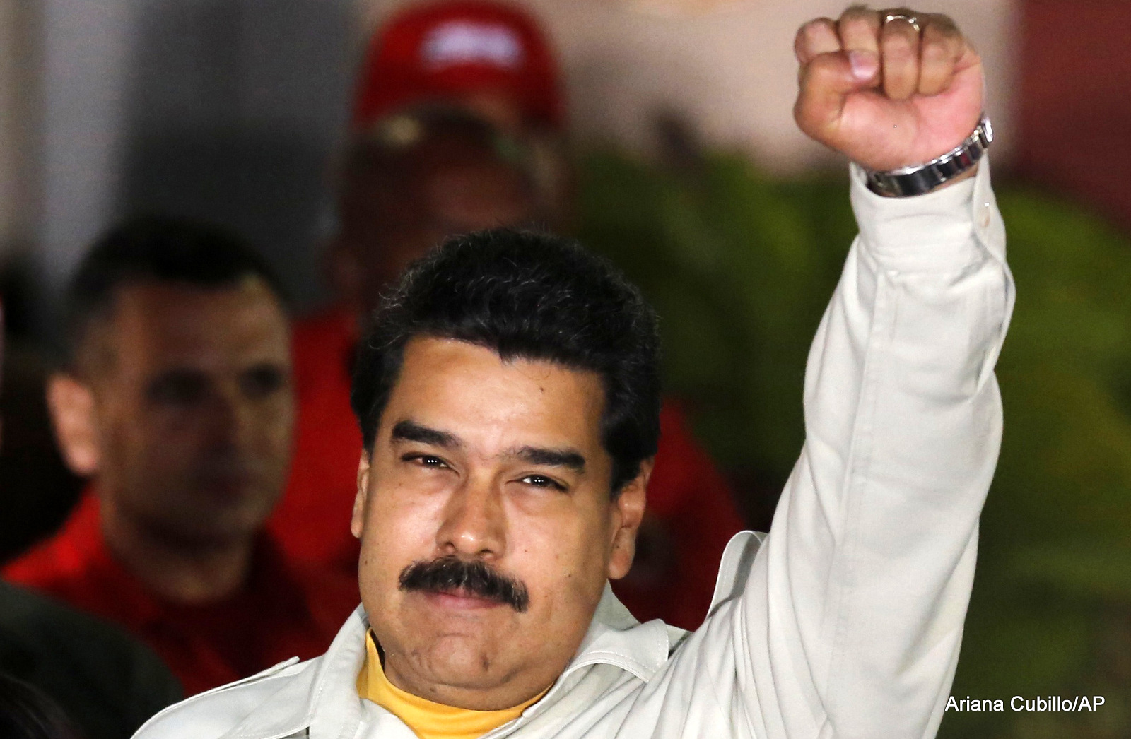 Venezuela's President Nicolas Maduro holds up a clenched fist as he greets supporters during an event at Miraflores presidential palace in Caracas, Venezuela. In a fiery speech late Monday, March 9, 2015.
