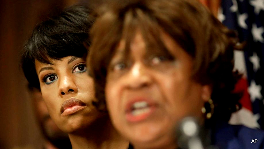 Baltimore Mayor Stephanie Rawlings-Blake listens as the Baltimore NAACP’s Tessa Hill-Aston speaks about Freddie Gray’s death.