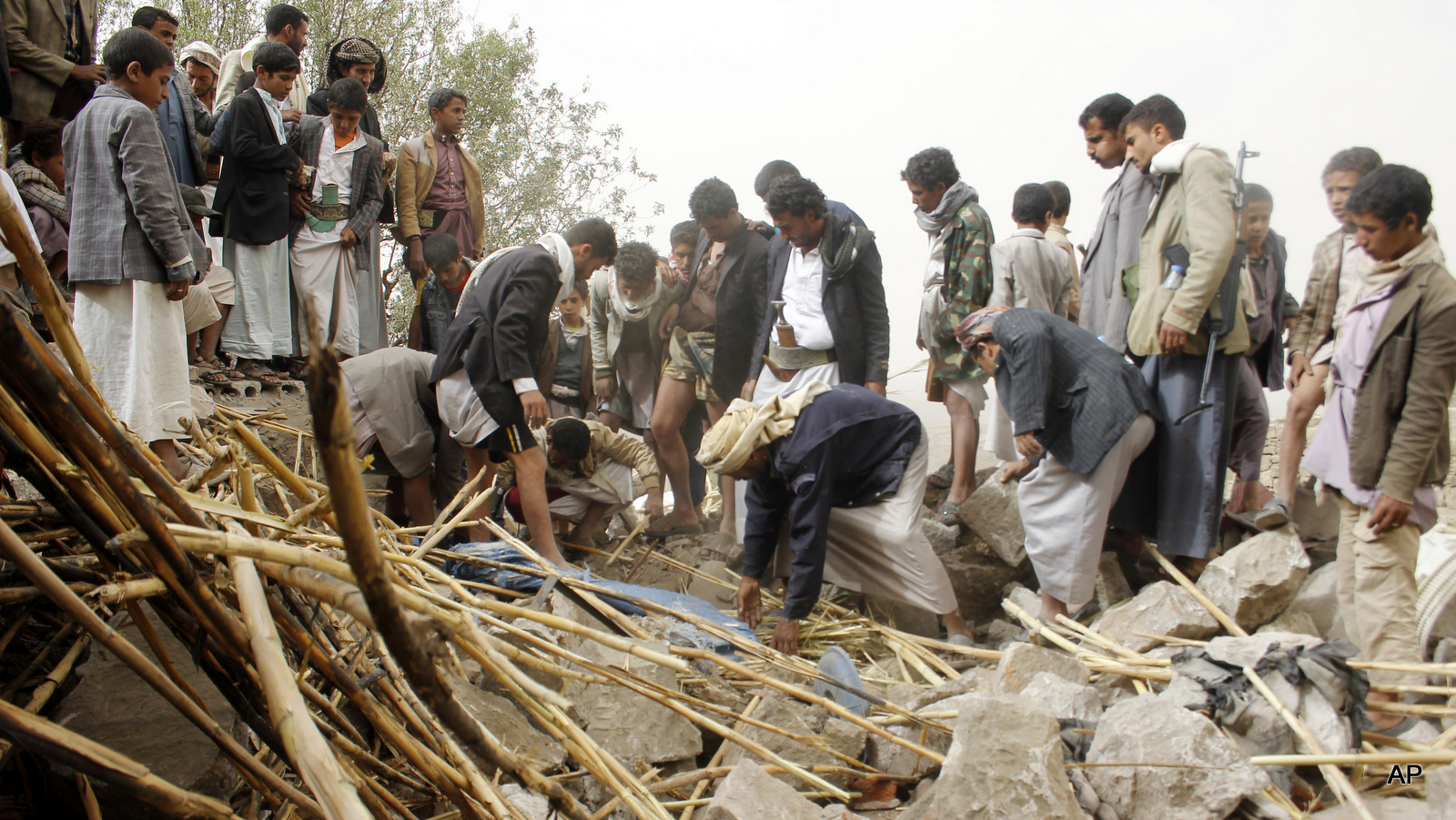 Yemenis search for survivors in the rubble of houses destroyed by Saudi-led airstrikes in a village near Sanaa, Yemen, Saturday, April 4, 2015.