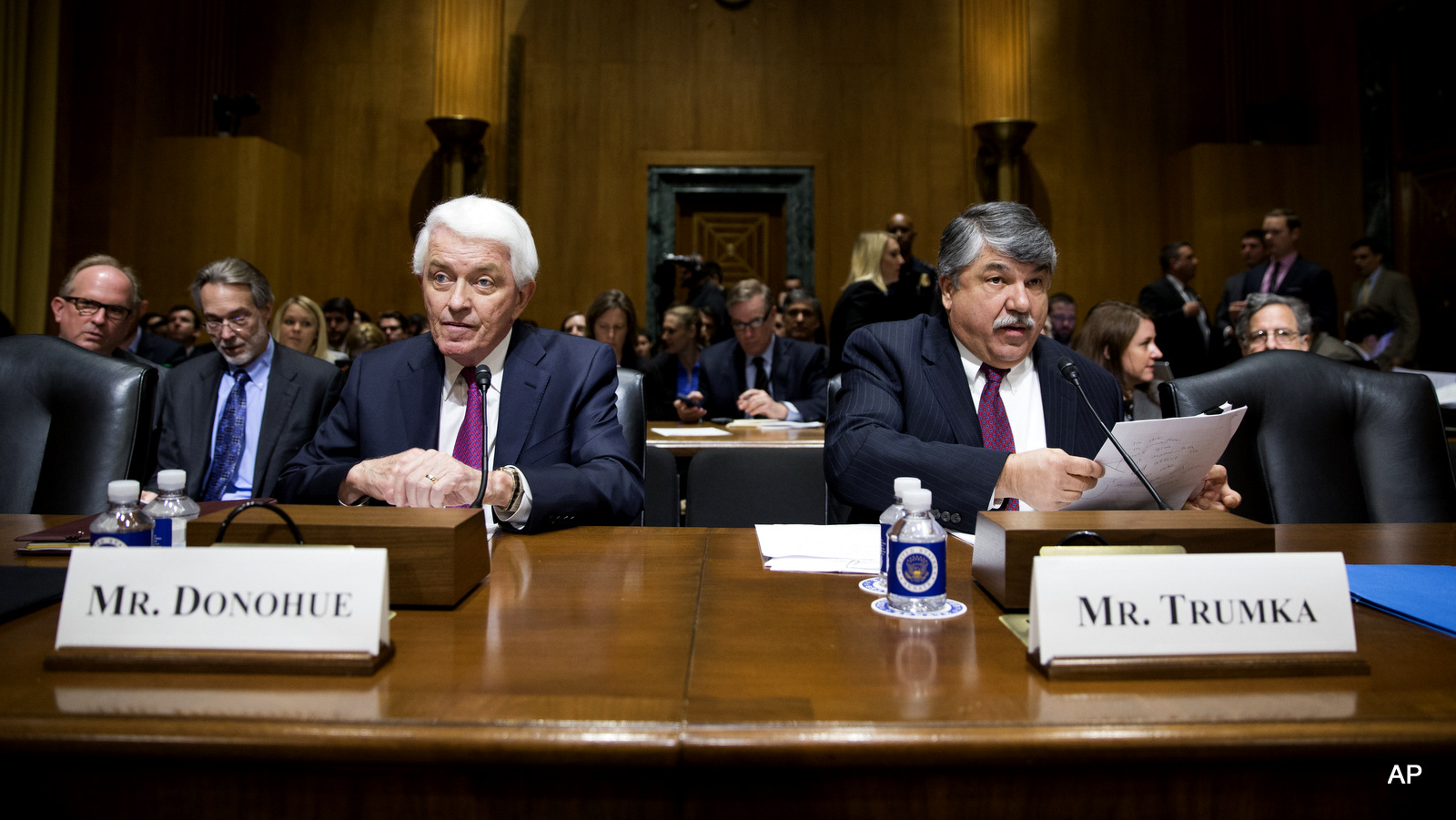 Major labor unions and business groups clashed Tuesday over President Barack Obama's bid for "fast track" authority to advance trade deals being negotiated with numerous nations. TAFL-CIO president Richard Trumka, right, and U.S. Chamber of Commerce President Tom Donohue prepare to testify on Capitol Hill in Washington, Tuesday, April 21, 2015, before a Senate Finance Committee hearing on Obama's bid for "fast track" authority to advance trade deals being negotiated with numerous nations.  in shaping trade deals.  