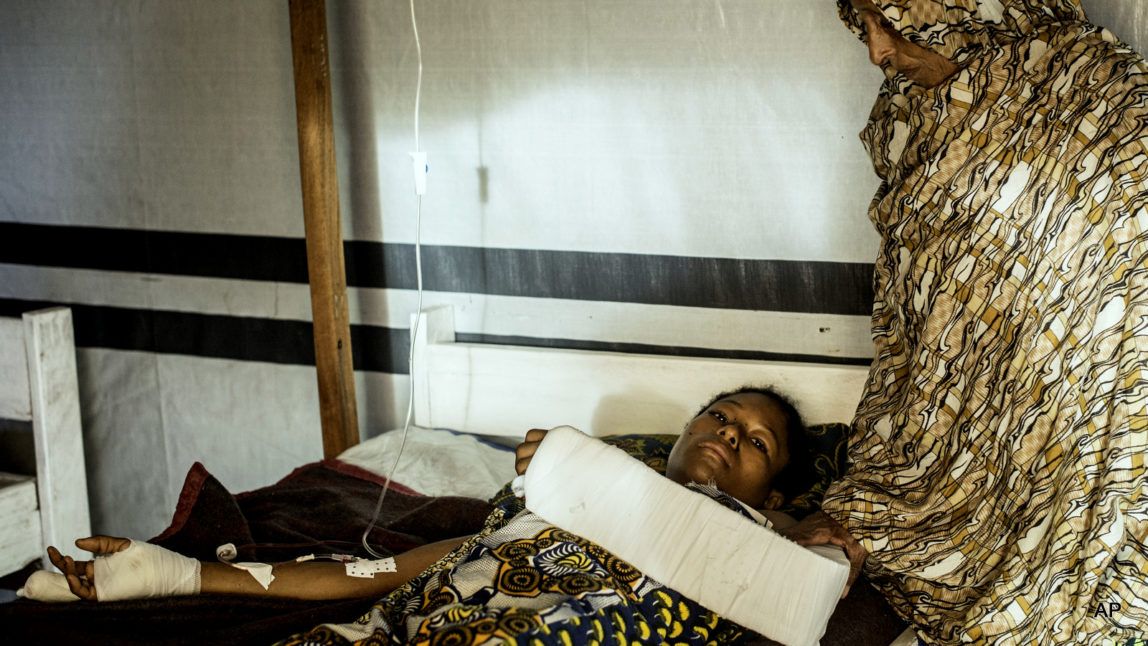 Aminatou Bello a 24-year-old Muslim, who was attacked by Christian Anti-Balaka forces, lies on a bed in Boda, Central African Republic.