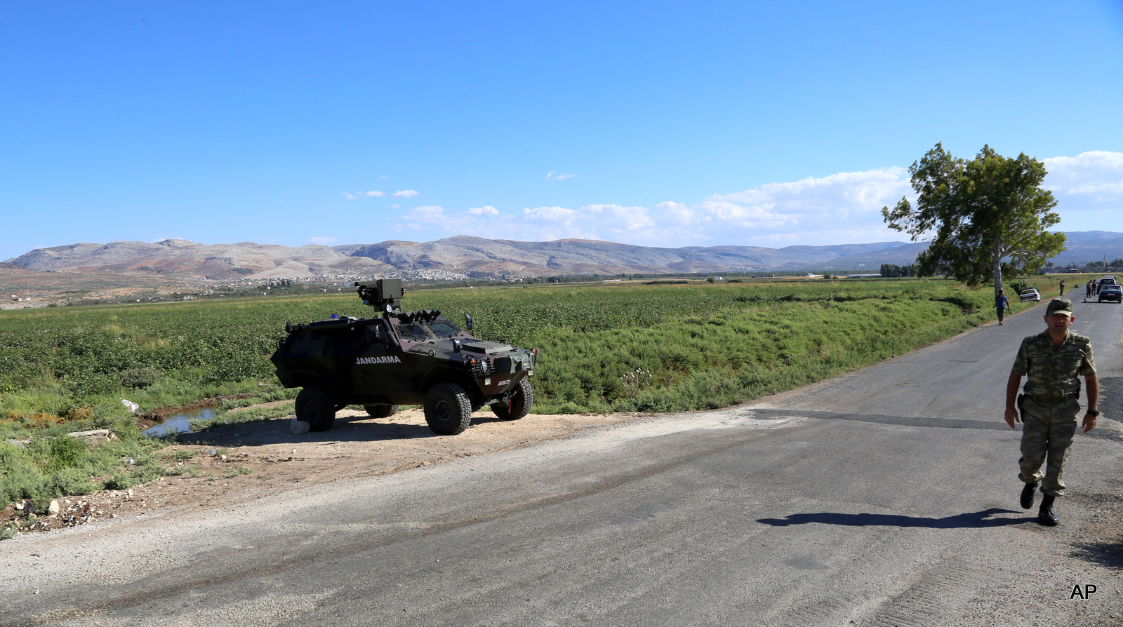 Turkish soldiers patrol a road near Hacipasa, Hatay, Turkey. At the peak of Turkey’s oil smuggling boom, the main transit point was a dusty hamlet called Hacipasa on the Orontes River that marks the border with Syria, Saturday, Sept. 20, 2014. Hacipasa has been a smuggling haven for decades, authorities and residents say. The fuel had come from oil wells in Iraq or Syria controlled by militants, including the Islamic State group, and was sold to middle men who smuggled it across the Turkish-Syrian border.