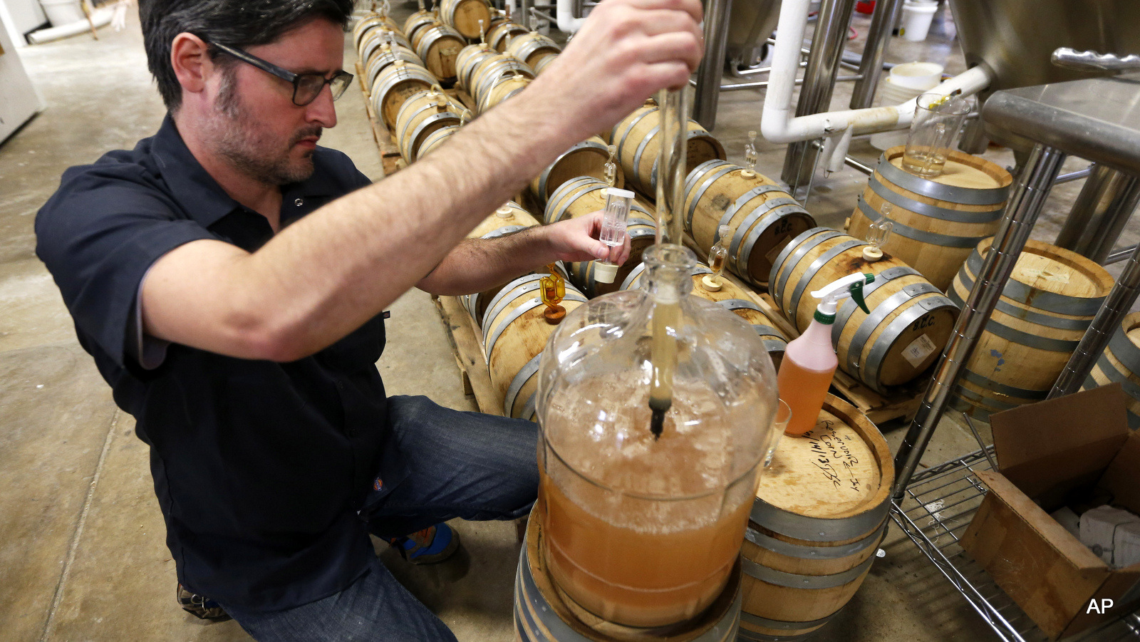 Co-Owner of Ardent Craft Ales, Kevin O'Leary, takes a sample of Persimmon beer at the facility in Richmond, VA., Tuesday, Dec. 2, 2014. 