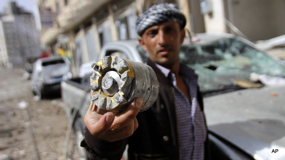 A man holds a cluster comb fragment after a Saudi-led airstrike in Yemen's capital, Monday, April 20, 2015. (AP Photo/Hani Mohammed)