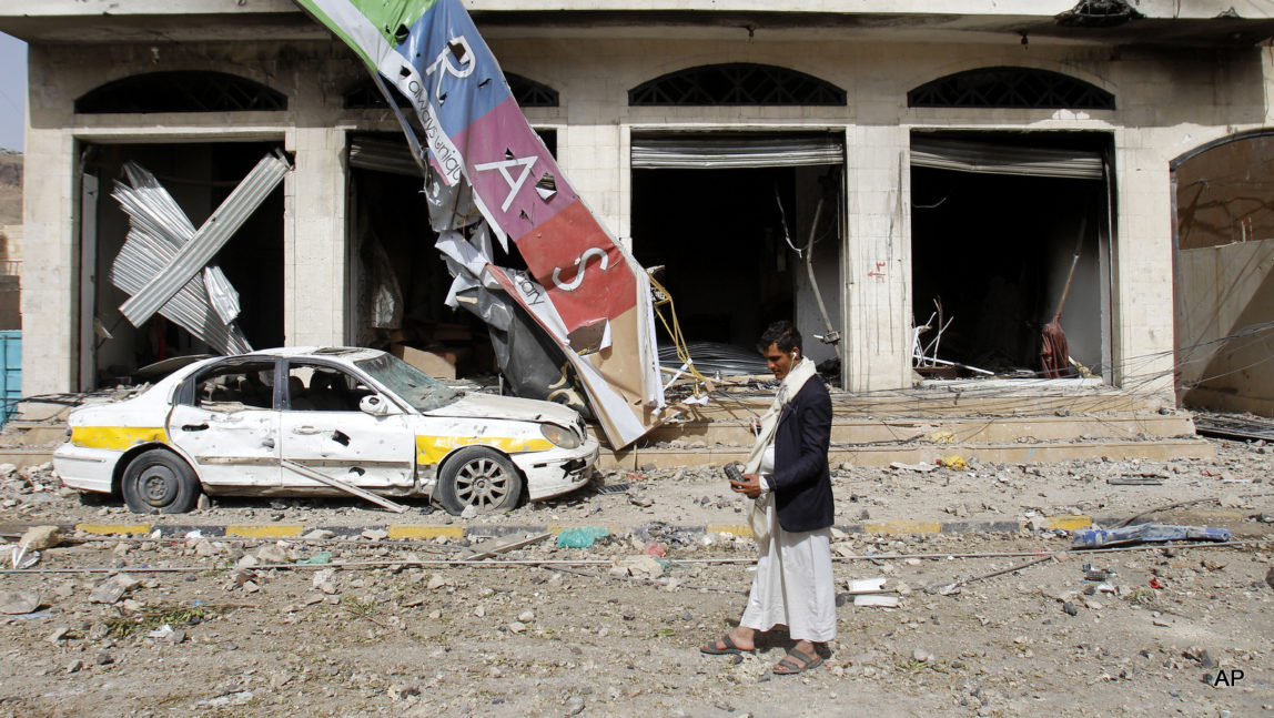 A street is littered with debris after a Saudi-led airstrike against Iran-allied Shiite rebels, known as Houthis, that targeted a site of a weapons cache in Yemen's capital, Monday, April 20, 2015. Airstrikes on weapons caches in Yemen's rebel-held capital on Monday caused massive explosions that shattered windows, sent residents scrambling for shelter and killed a local TV presenter. (AP Photo/Hani Mohammed)