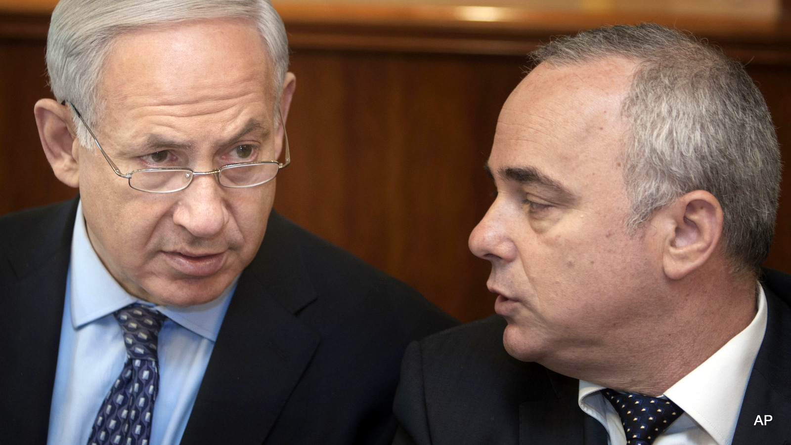 Israeli Prime Minister Benjamin Netanyahu, left, sits together with Finance Minister Yuval Steinitz, as they attend the weekly cabinet meeting in his Jerusalem office. Steinitz on Monday said taking military action against Iran’s nuclear program is still an option, despite last week’s framework deal between world powers and Iran