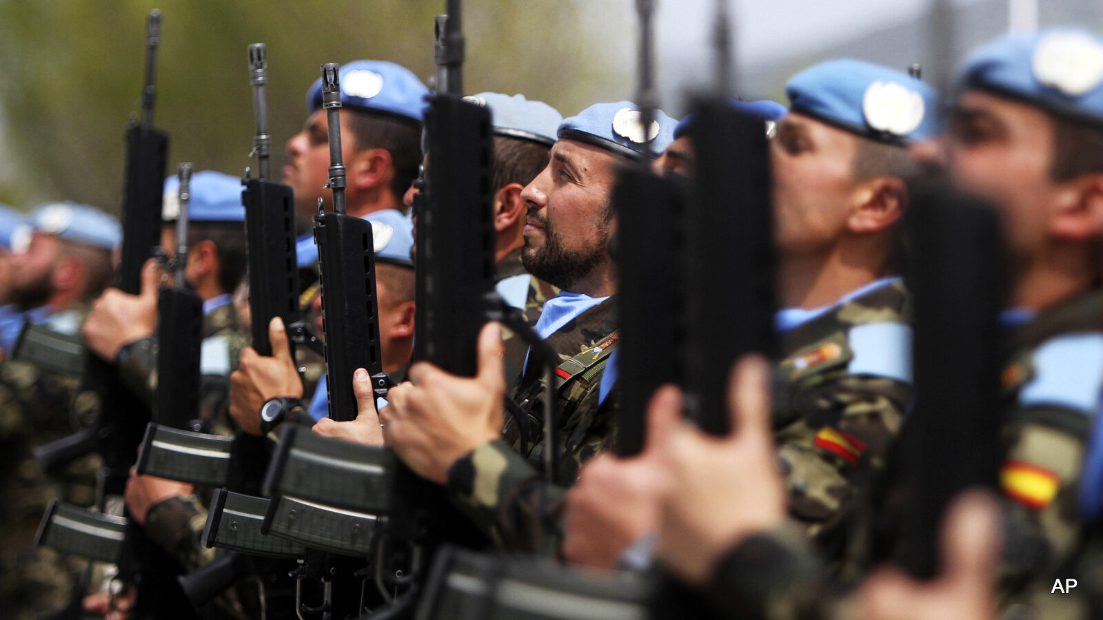 Members of the Spanish U.N. peacekeepers honor guard hold their rifles as they receive Spain's King Felipe VI during his visit to their base in the southern village of Blatt, Lebanon, Wednesday, April 8, 2015. (AP Photo/Mohammed Zaatari)