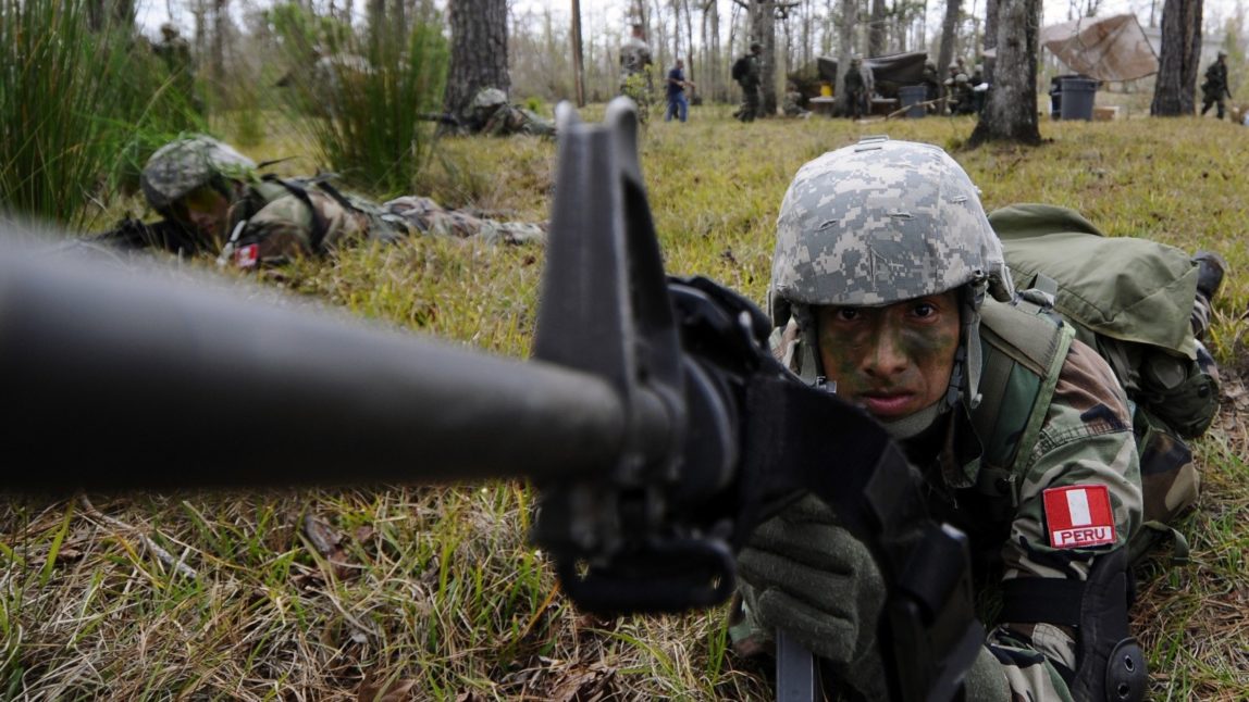 Students from the Western Hemisphere Institute for Security Cooperation and students from the Naval Small Craft Instruction and Technical Training School conduct a joint assault on a simulated narcotics camp during a field training exercise. (Photo: U.S. Navy)