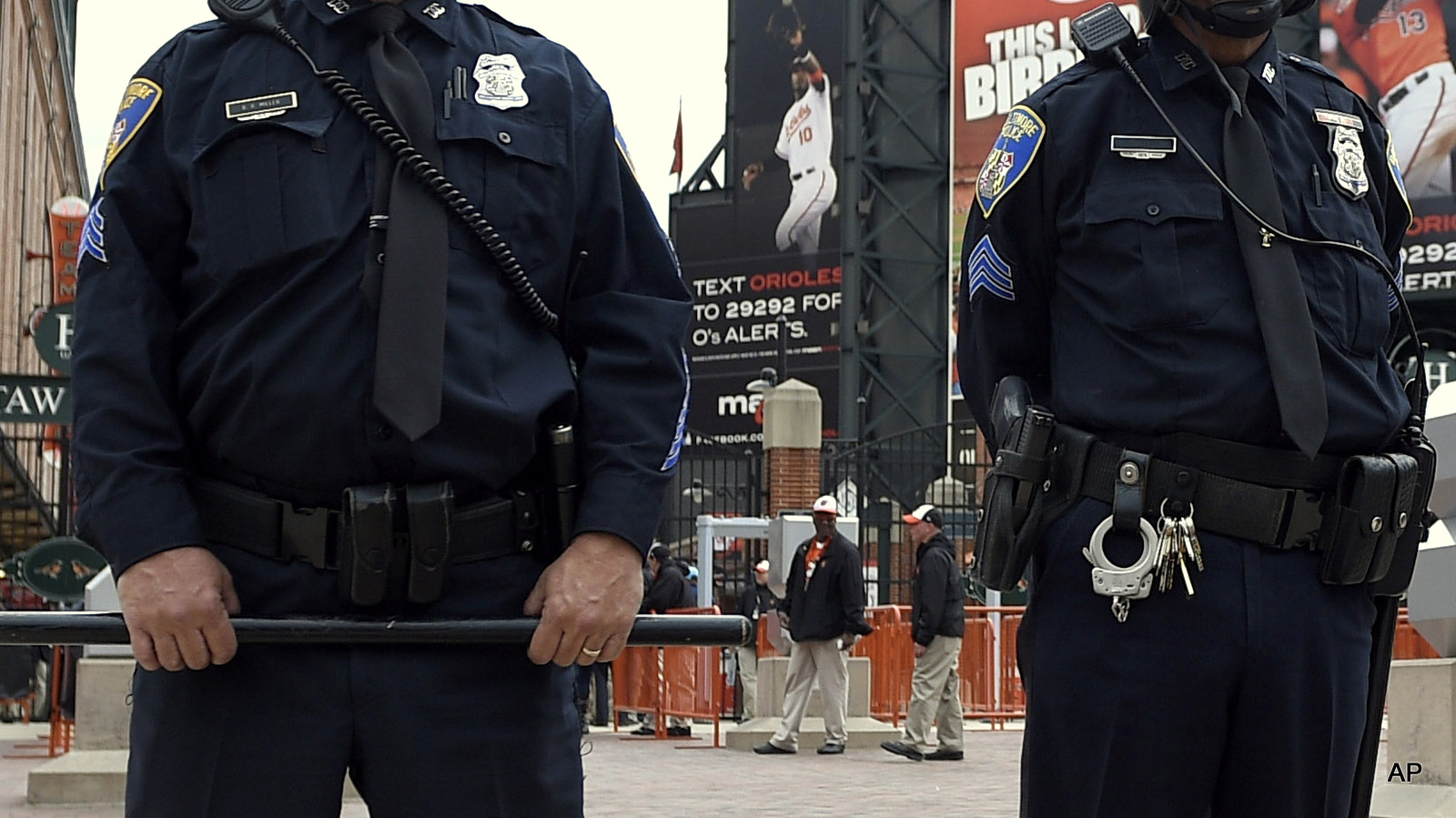 Baltimore police officers stand outside of Oriole Park at Camden Yards, Monday, April 27, 2015, in Baltimore. 