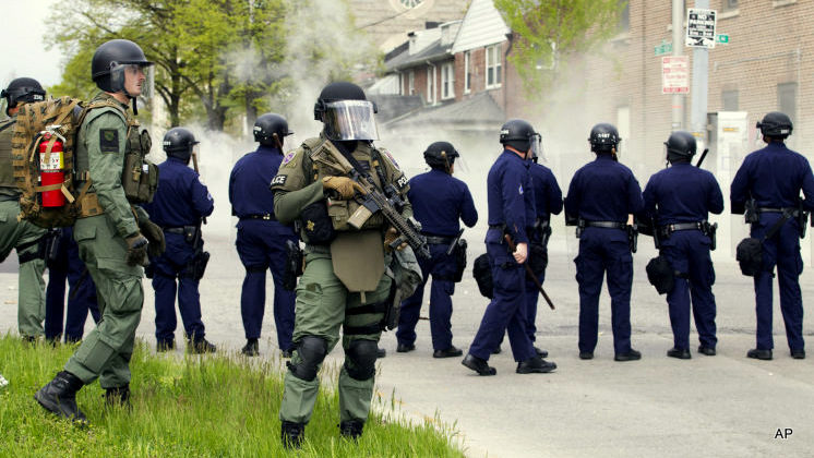 Baltimore police officers respond to demonstrators after the funeral of Freddie Gray, Monday, April 27, 2015, in Baltimore.