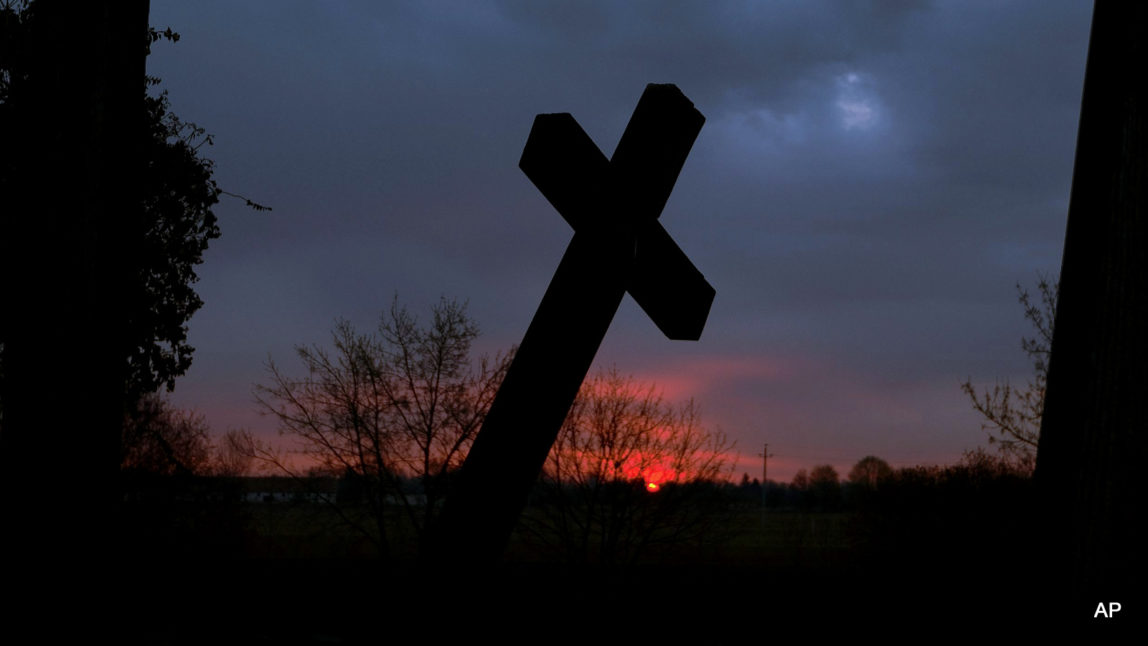 Crosses at a war memorial stand in front of the dawning sky at Muhi, 167 kms northeast of Budapest, Hungary, on Easter Sunday, April 5, 2015. (AP Photo/MTI, Zsolt Czegledi)