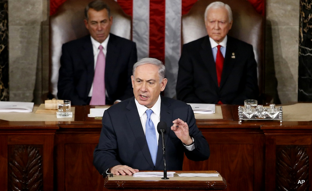 Israeli Prime Minister Benjamin Netanyahu speaks before a joint meeting of Congress on Capitol Hill in Washington, Tuesday, March 3, 2015. Netanyahu said the world must unite to `stop Iran's march of conquest, subjugation and terror'. House Speaker John Boehner of Ohio, left, and Sen. Orrin Hatch, R-Utah listen. 