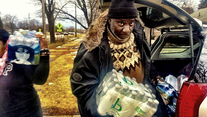 Detroit Water Brigade Senior Advisor Rodney 'Radio RAHIM' Deas volunteering to deliver water to the Eight Mile & Telegraph area.