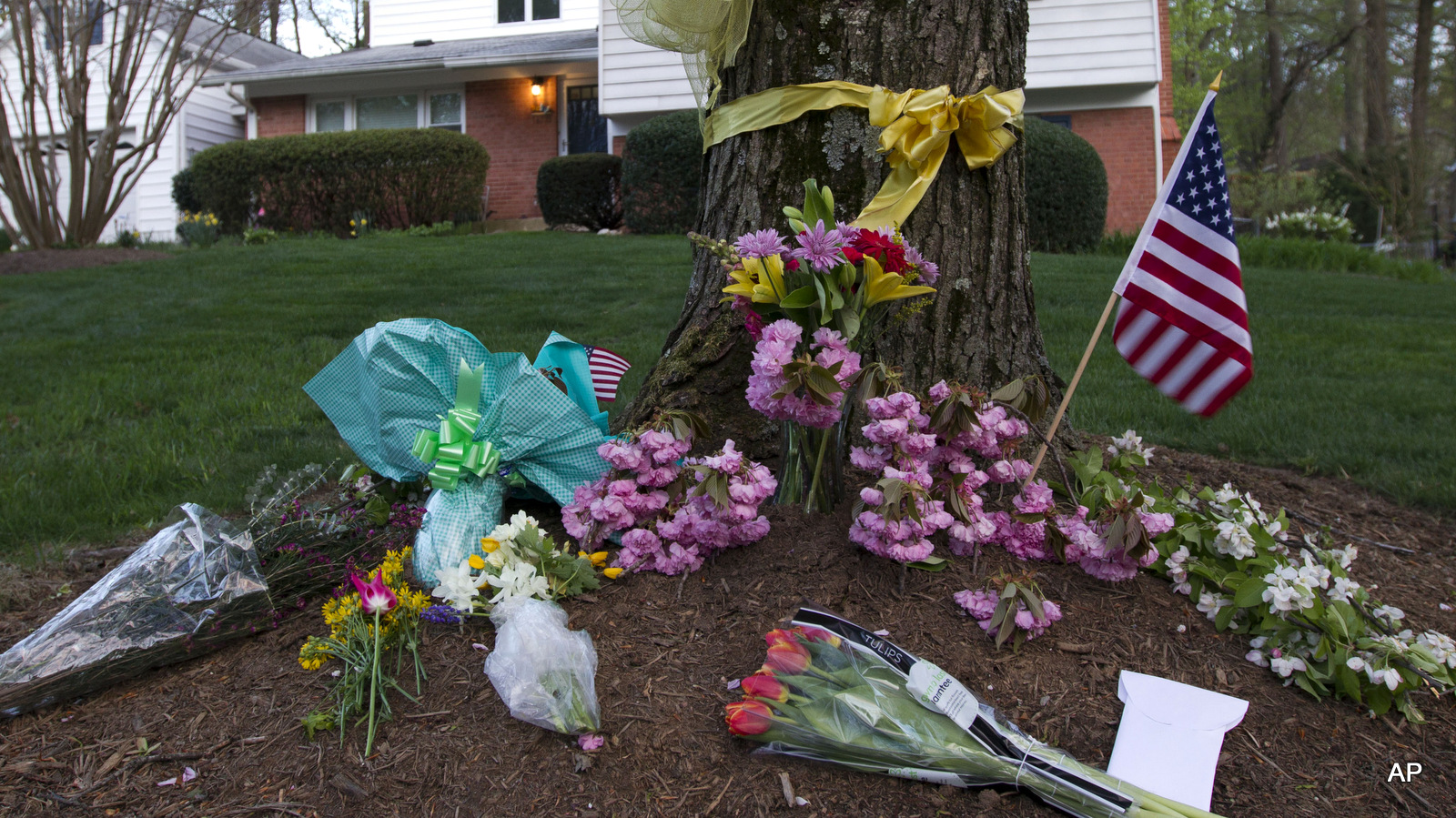 Flowers and ribbons adorn a tree outside the Weinstein family house in Rockville, Md., Thursday, April 23, 2015.  Weinstein is one of over 30 Westerns killed by Covert U.S. drone strikes. 