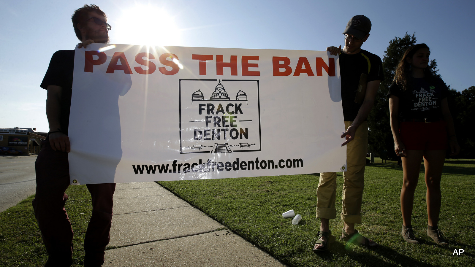 Residents of Denton, Texas, hold a campaign sign outside city hall, in Denton, Texas. Texas moved to ban its own cities from imposing prohibitions on hydraulic fracturing and other potentially environmentally harmful oil and natural gas drilling activities within their boundaries _ a major victory for industry groups and top conservatives who have decried rampant local “overregulation.” 