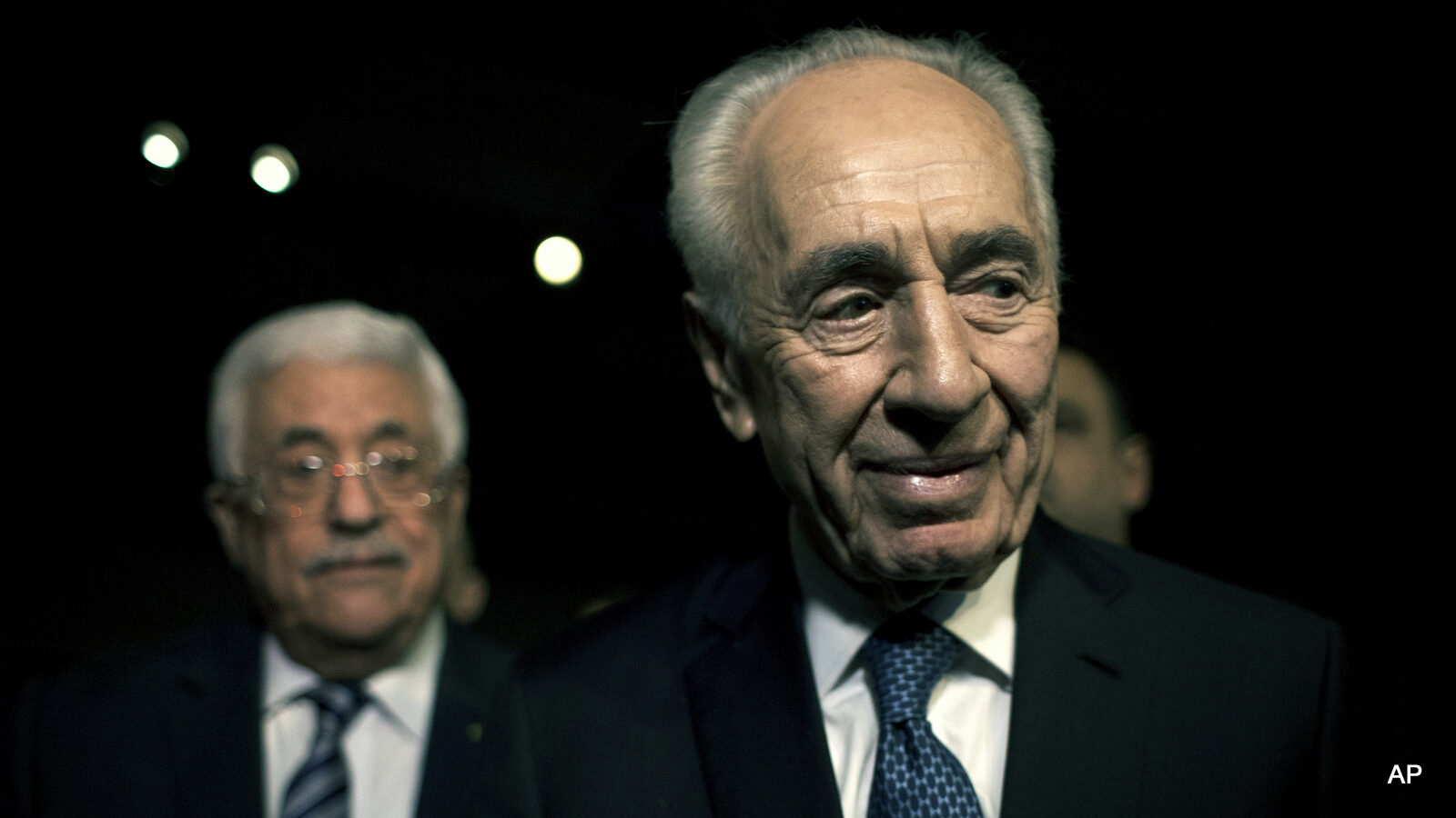 Former Israeli President Shimon Peres, right and Palestinian President Mahmoud Abbas arrive to attend the opening session of the World Economic Forum at the King Hussien convention center, Southern Shuneh, Jordan, Friday, May 22, 2015. Palestinian President Mahmoud Abbas on Friday said Israel is blocking peace by continuing to expand settlements on occupied territory, but reaffirmed his support for a two-state solution based on the pre-1967 border.