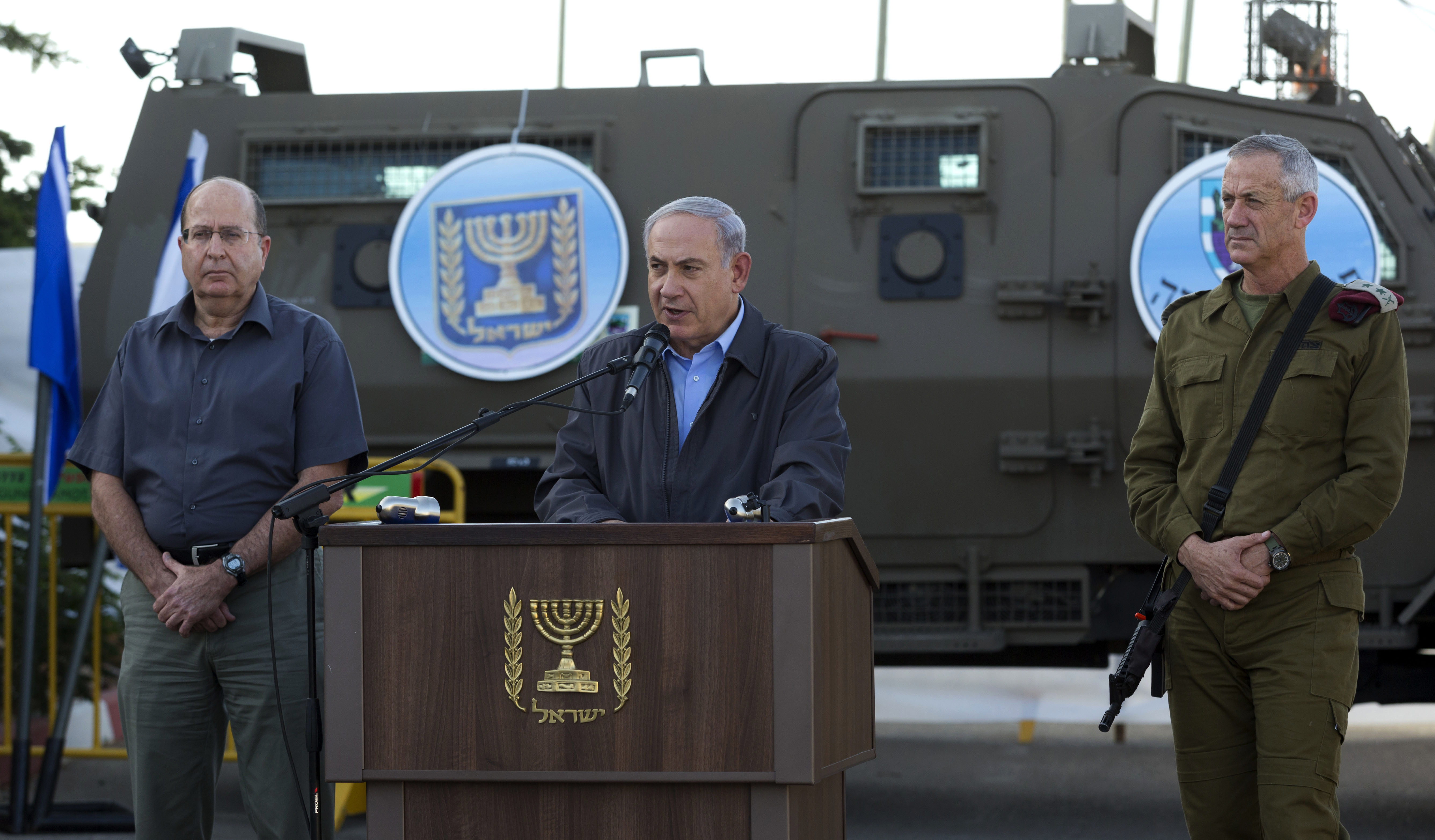 Israeli Prime Minister Benjamin Netanyahu, center, Chief of Staff Lt. Gen. Benny Gantz, right, and the Israeli Defense Minister Moshe Ya'alon, left, give a statement to the press (AP Photo/Jim Hollander)