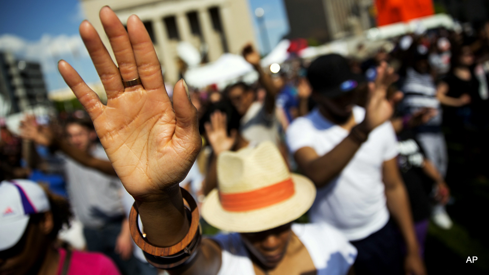 People pray during a rally at City Hall, Sunday, May 3, 2015, in Baltimore. Hundreds of jubilant people prayed and chanted for justice days after the city's top prosecutor charged six officers involved in Freddie Gray's arrest. Gov. Larry Hogan has called for a statewide "Day Of Prayer And Peace" on Sunday after civil unrest rocked Baltimore. 