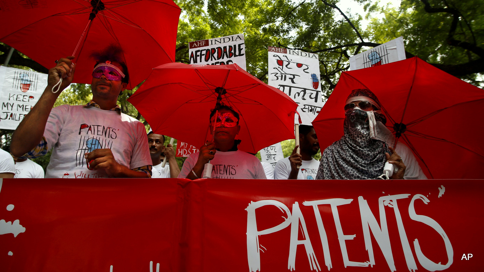 Protest urge the Indian government to refrain from signing the Trans Pacific Partnership agreement, in New Delhi, India, they are concerned that the agreement will impose severe restrictions on the Indian generic drugs manufacturers and will raise the price of life saving drugs severely, affecting thousands across the globe who can only barely afford the Indian made generic drugs. Placard reads "Patent and greed leads to death."