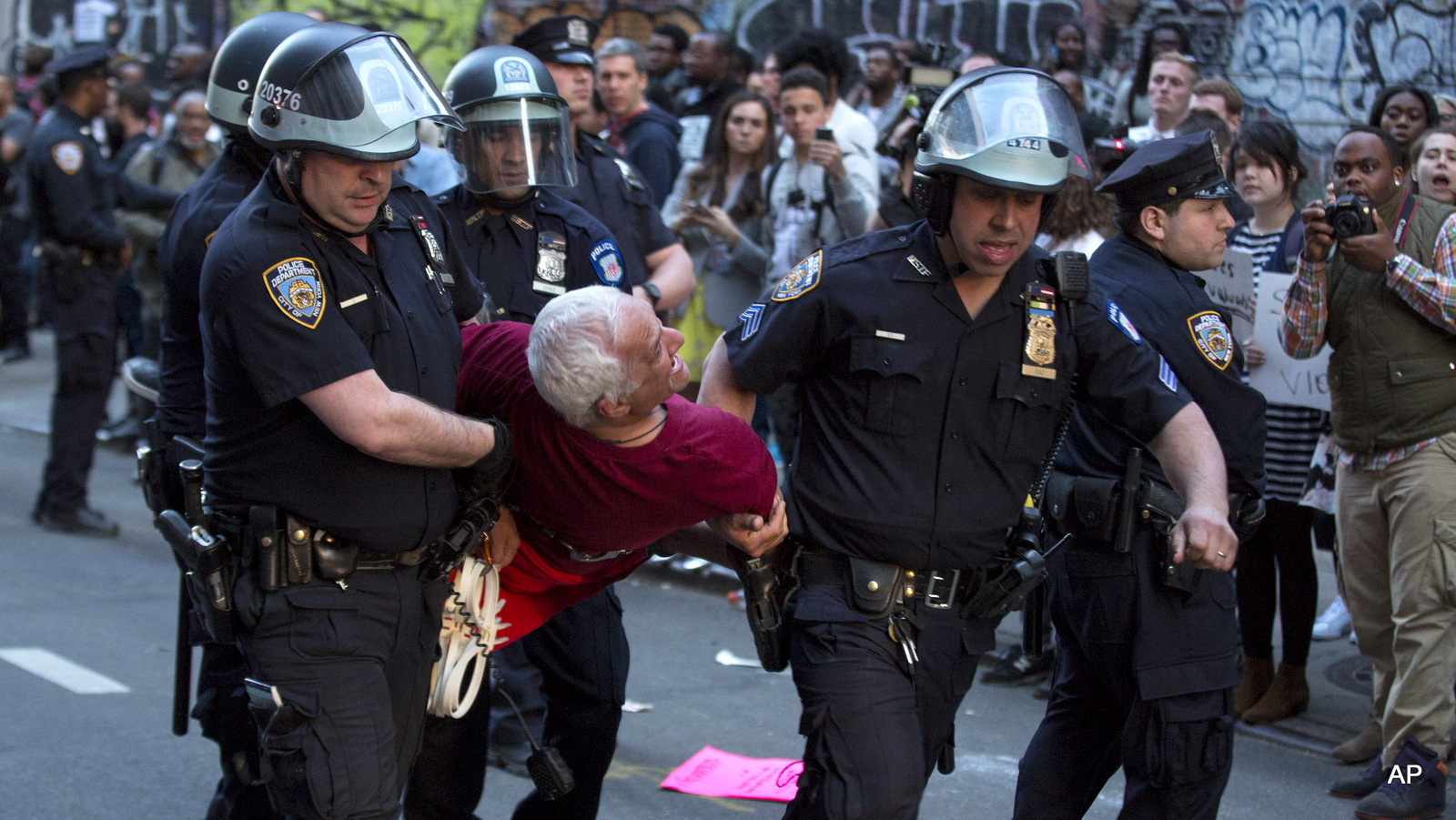 A man is carried by police officers as arrests are made near Union Square, Wednesday, April 29, 2015, in New York. People gathered to protest the death of Freddie Gray, a Baltimore man who was critically injured in police custody.