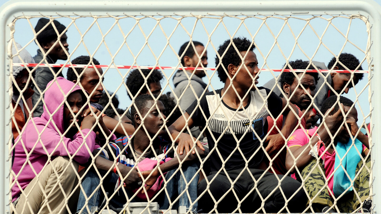 Migrants wait to disembark from the Italian Navy vessel 'Bettica' in the harbor of Salerno, Italy, Tuesday, May 5, 2015. About 700 migrants, including children, were rescued in the Sicilian Strait while they were trying to cross. (AP Photo/Francesco Pecoraro)