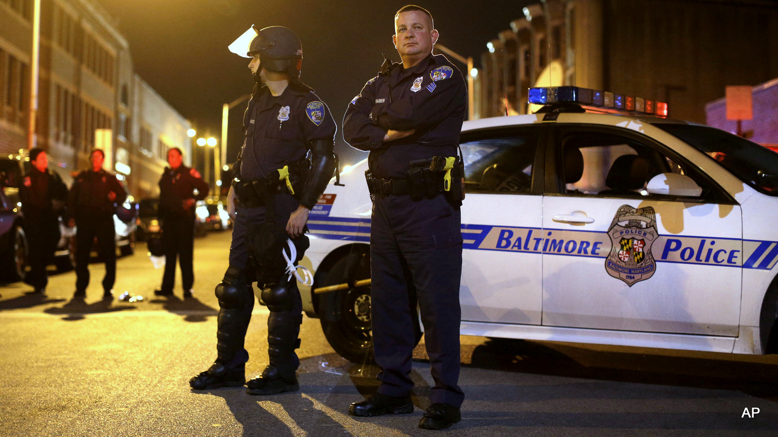 Members of the Baltimore Police Department wait for curfew to begin for the third night, Thursday, April 30, 2015, in Baltimore.