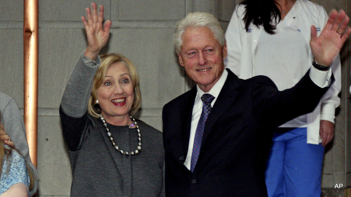 Former President Bill Clinton and former Secretary of State Hillary Rodham Clinton wave to the media after the family leaves Manhattan's Lenox Hill hospital in New York.