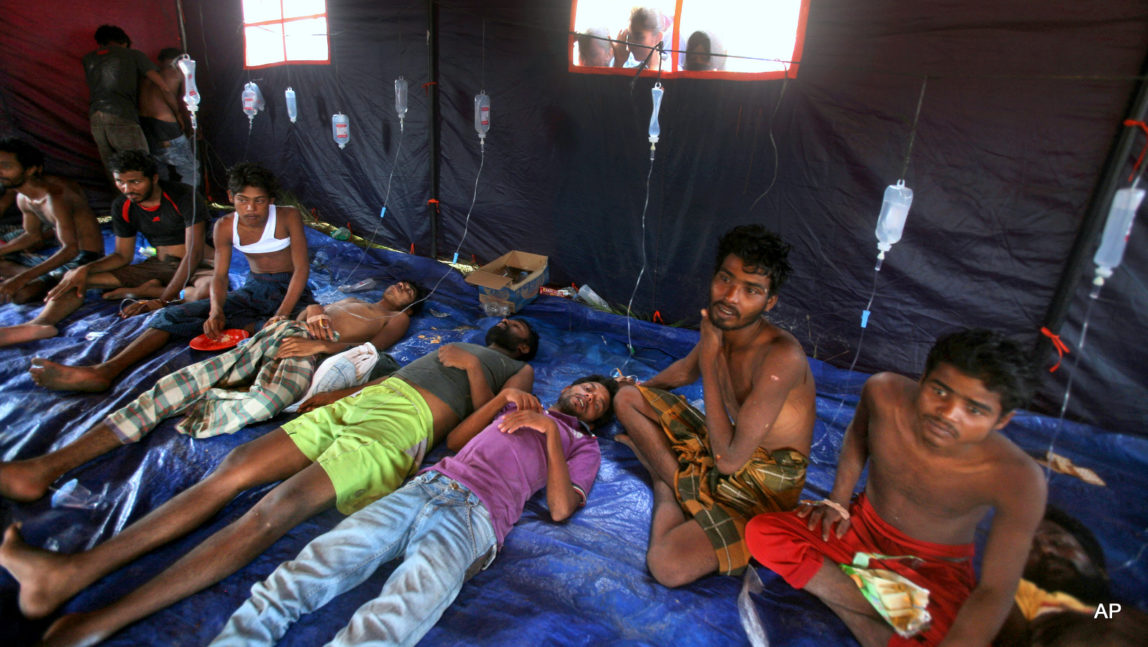 Newly arrived migrants receive medical treatment inside a makeshift tent at Kuala Langsa Port in Langsa, Aceh province, Indonesia, Friday, May 15, 2015. More than 1,000 Bangladeshi and ethnic Rohingya migrants came ashore in different parts of Indonesia and Thailand on Friday, becoming the latest refugees to slip into Southeast Asian countries that have made it clear the boat people are not welcome.